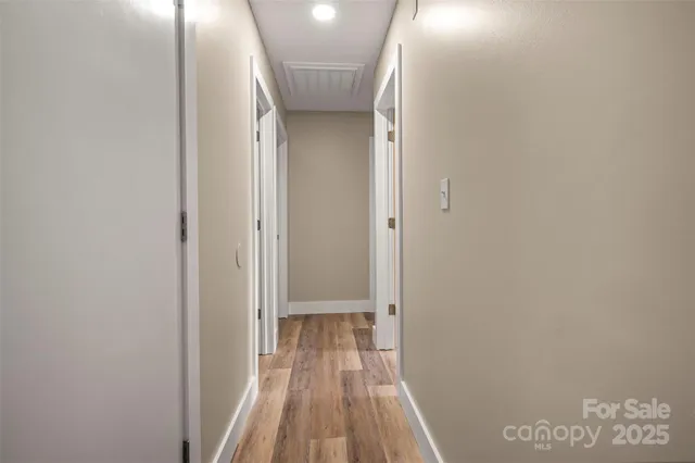 a view of a room with wooden floor
