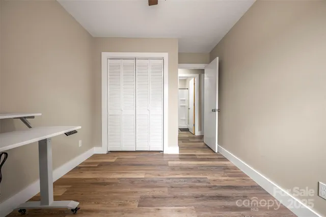 a view of a kitchen with wooden floor and a sink