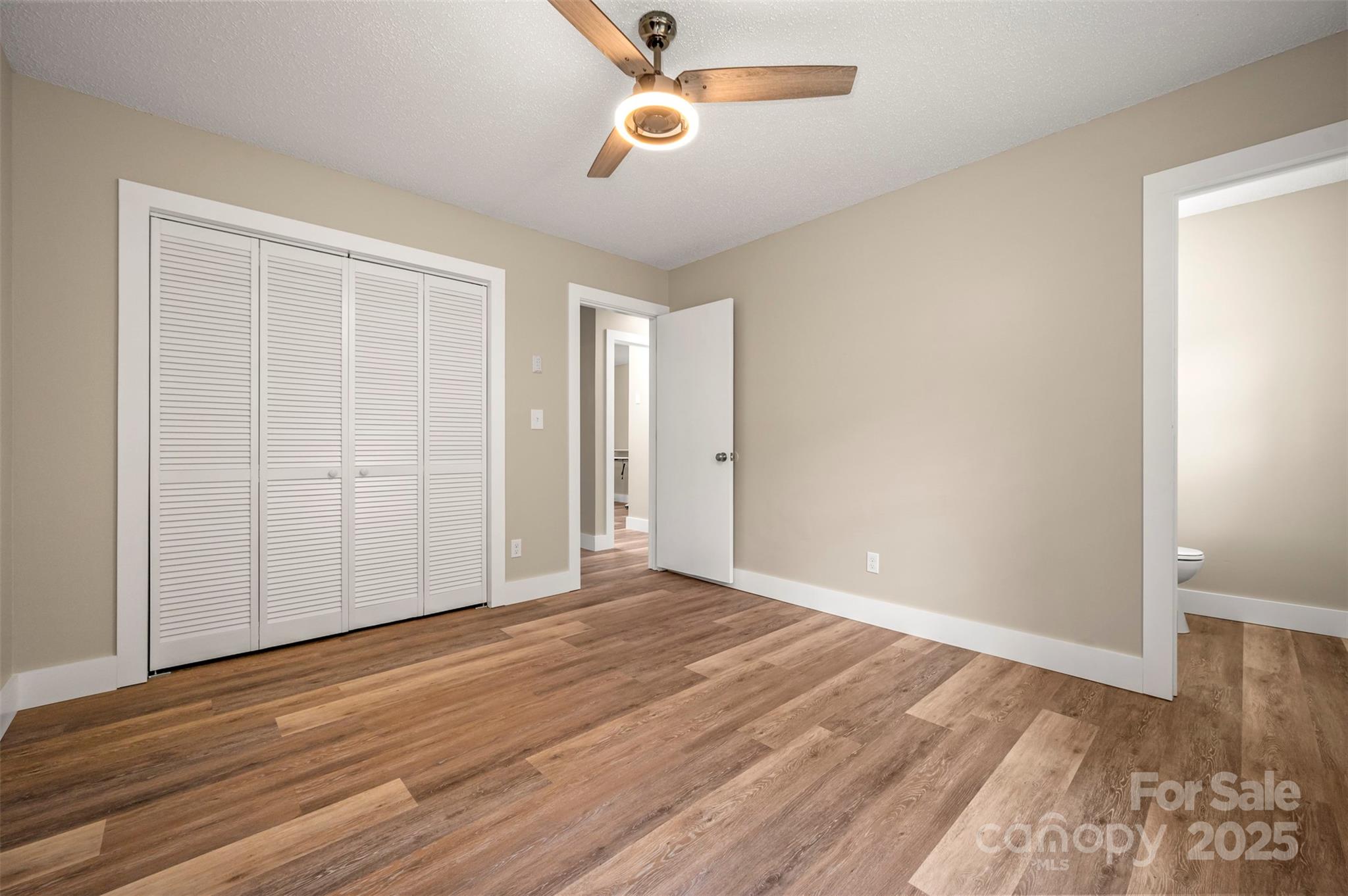 569 Lanning Road Hendersonville, NC 28792 - Photo 25 of 32 an empty room with wooden floor cabinet and windows