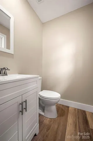 a bathroom with a sink a toilet and vanity