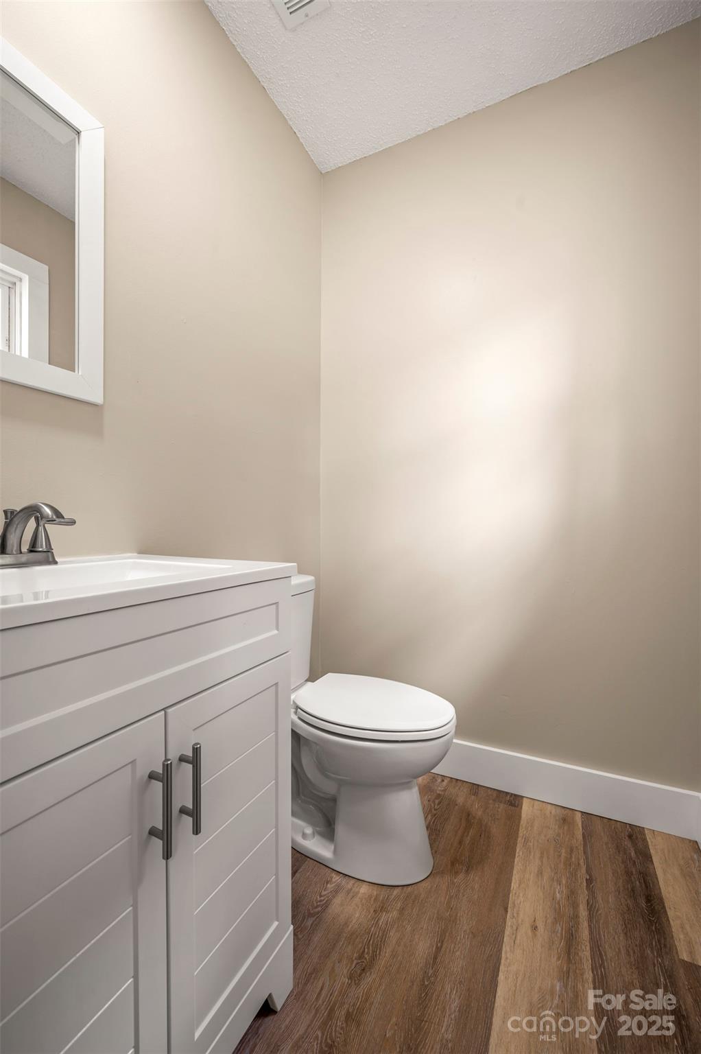 569 Lanning Road Hendersonville, NC 28792 - Photo 26 of 32 a bathroom with a sink a toilet and vanity