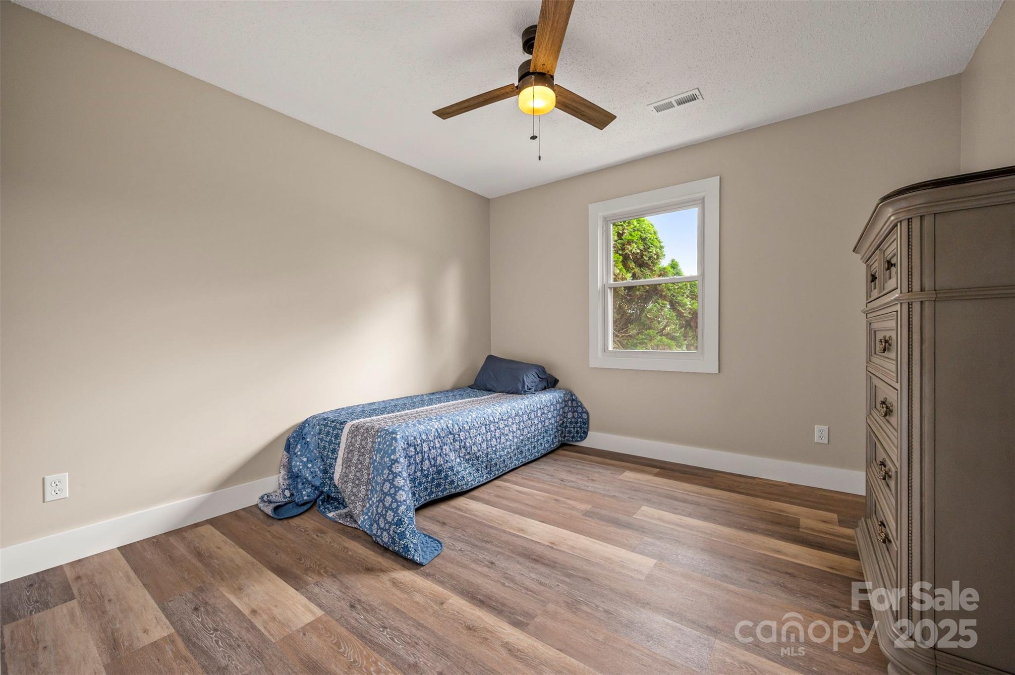 569 Lanning Road Hendersonville, NC 28792 - Photo 27 of 32 a bedroom with a bed and a chandelier