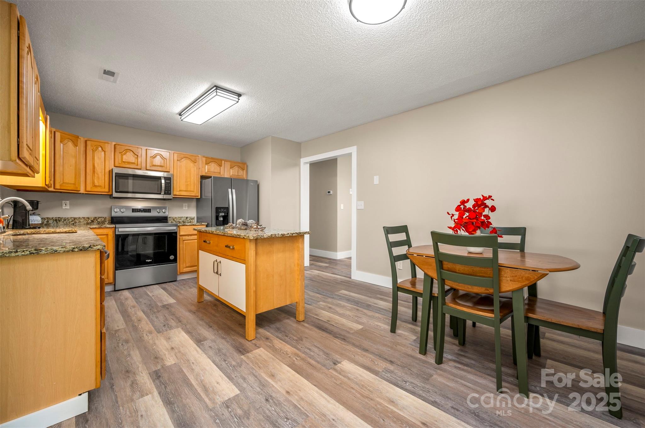 569 Lanning Road Hendersonville, NC 28792 - Photo 9 of 32 a kitchen with granite countertop furniture wooden floor dining table and chairs