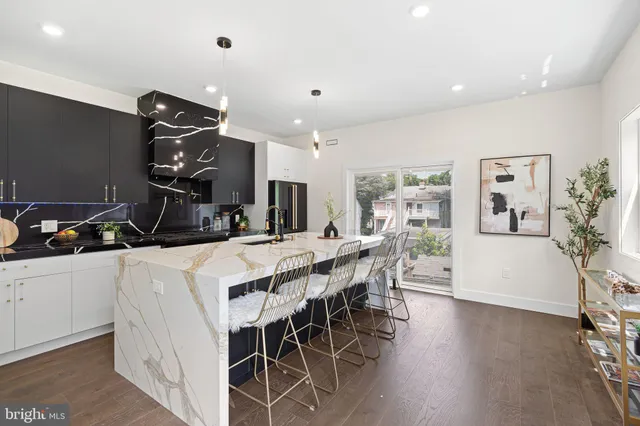 a kitchen with stainless steel appliances a sink stove and cabinets