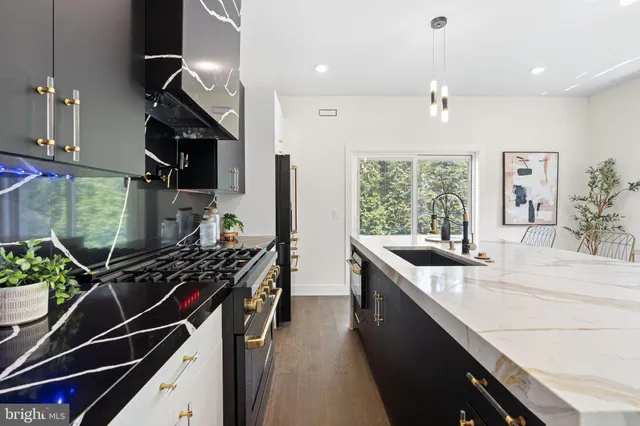 a view of a kitchen with kitchen island a sink a counter space and a window