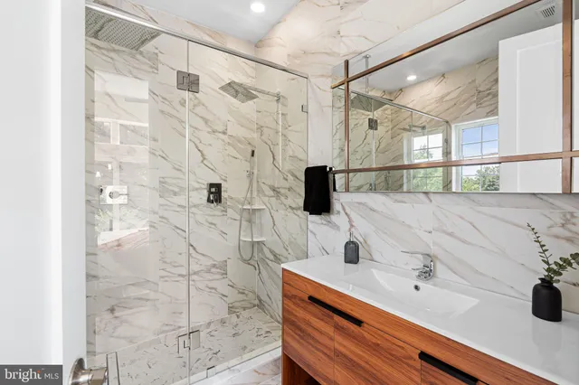 an empty room with ceiling fan and wooden floor
