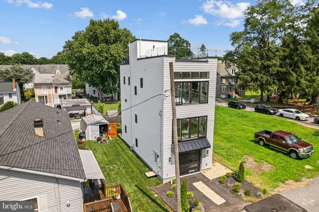 an aerial view of a house with a yard