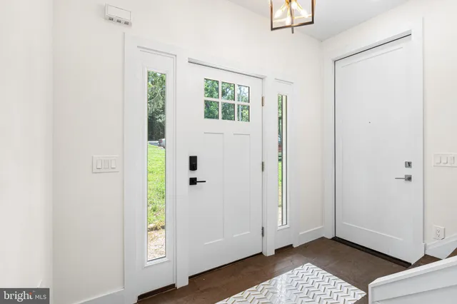 a view of an entryway with wooden floor