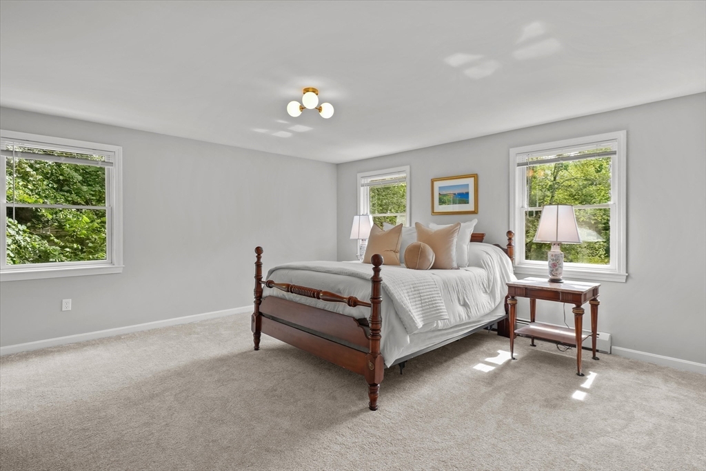 50 Middle Road Amesbury, MA 01913 - Photo 13 of 30 a bed room with a bed and a chair