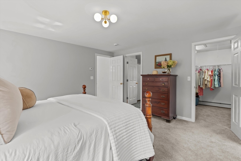 50 Middle Road Amesbury, MA 01913 - Photo 14 of 30 a bedroom with a bed and a refrigerator