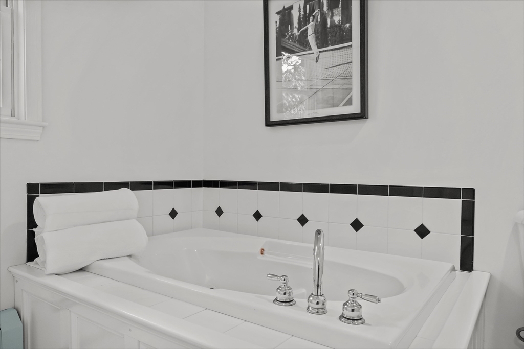 50 Middle Road Amesbury, MA 01913 - Photo 17 of 30 a bath tub sitting next to a white sink and a vanity