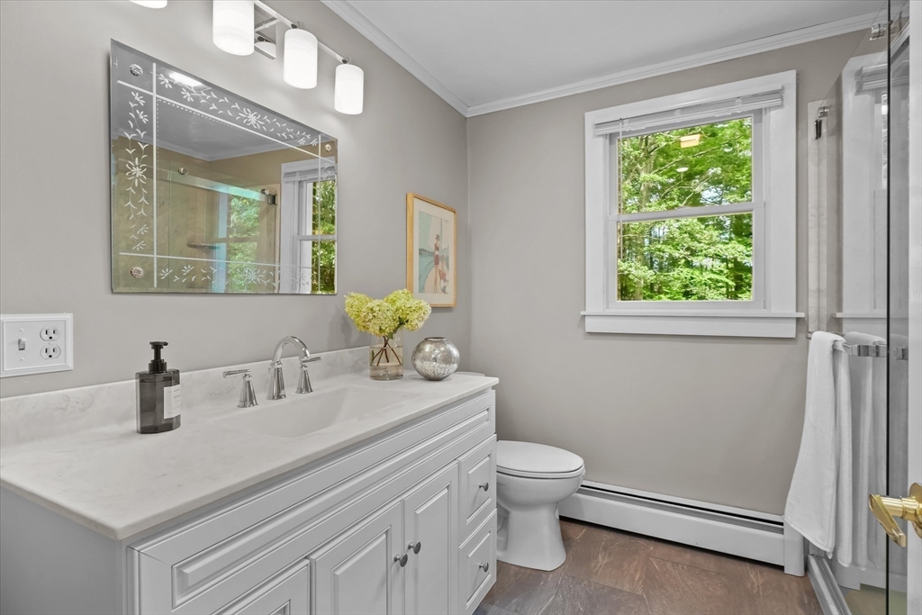 50 Middle Road Amesbury, MA 01913 - Photo 21 of 30 a bathroom with a toilet a sink a mirror and a window