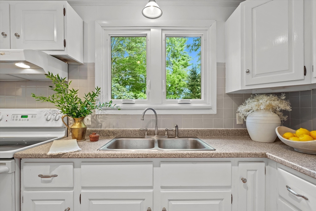50 Middle Road Amesbury, MA 01913 - Photo 8 of 30 a kitchen with stainless steel appliances white cabinets and a window