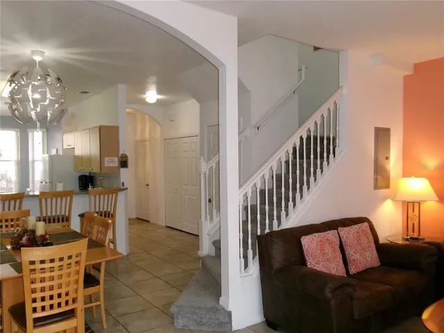 a living room with furniture and a lamp