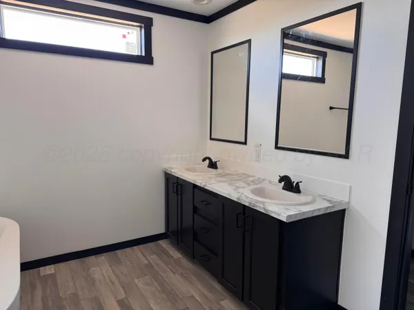 a bathroom with 2 sink and a mirror