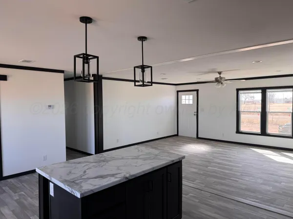 a view of a kitchen with a sink and wooden floor