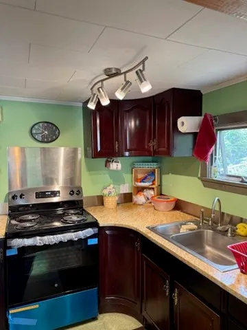 a kitchen with a stove a sink and cabinets