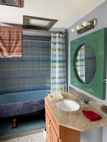 a room with a large bed and a dresser