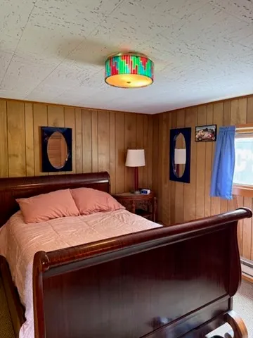 a bedroom with a bed lamps and a table in it