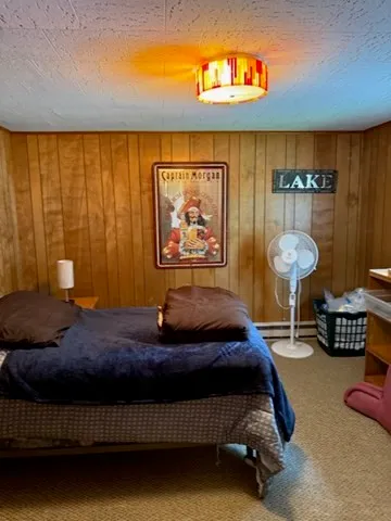 a bedroom with a bed and wall painting