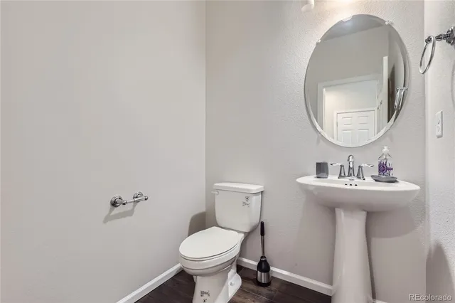 a bathroom with a sink a toilet and mirror