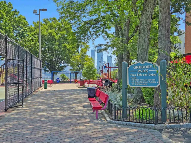 a view of a big house with fountain in front of it
