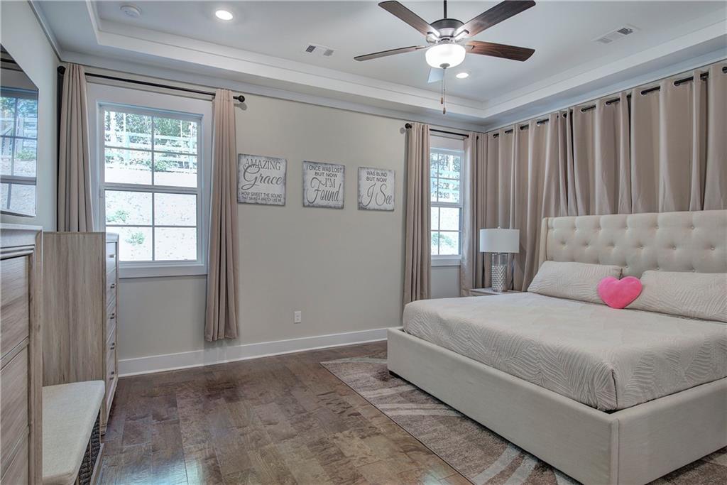 503 London Road Ball Ground, GA 30107 - Photo 20 of 55 a bedroom with a large bed and a chandelier