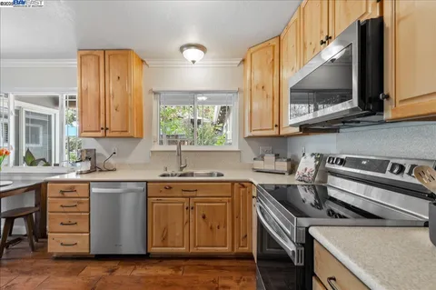 a kitchen with a stove a sink and a refrigerator