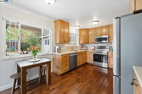a kitchen with stainless steel appliances a refrigerator a stove a sink and a center island