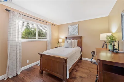 a bedroom with a bed and a potted plant