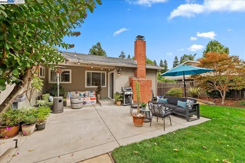 a view of a patio with chairs and a fire pit