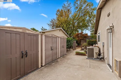 a view of a house with backyard sitting area and garden
