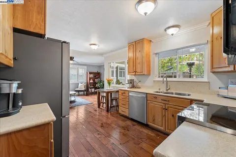 a kitchen with a sink stove and microwave