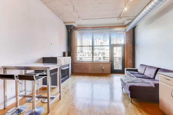 a view of workspace with furniture wooden floor and windows