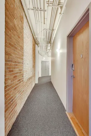 a view of a hallway with wooden walls