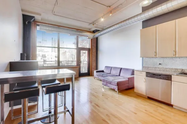 a living room with furniture and large windows
