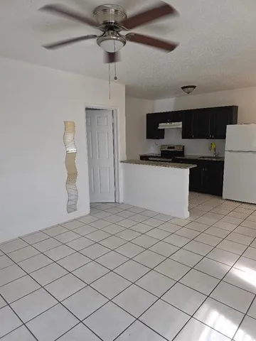 a kitchen with stainless steel appliances a refrigerator and a stove top oven