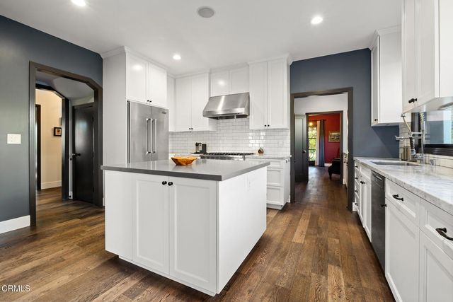 a kitchen with stainless steel appliances granite countertop a stove and a sink