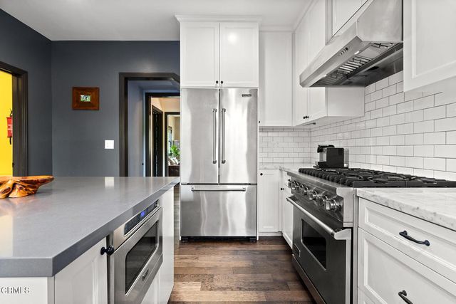 a hallway with mirror and a window