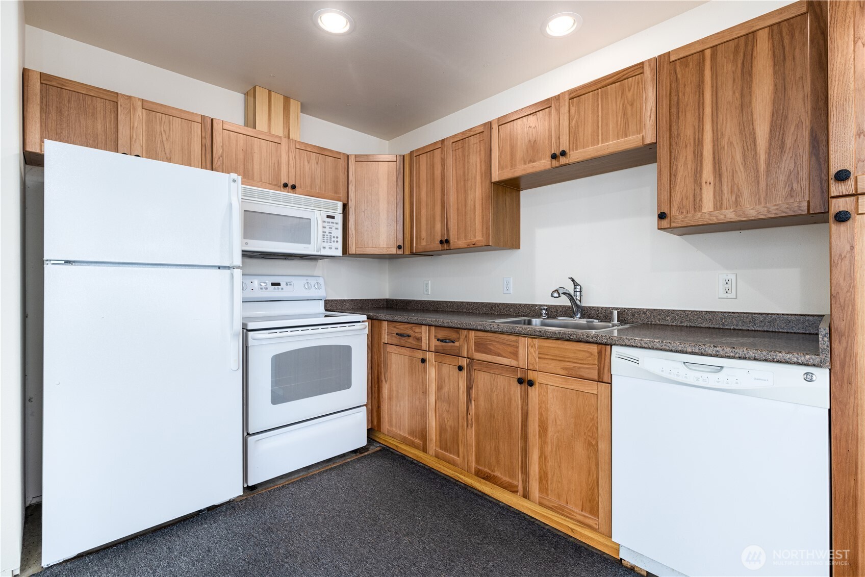 1901 E Trail Belfair, WA 98528 - Photo 26 of 40 a kitchen with stainless steel appliances granite countertop a refrigerator sink and cabinets