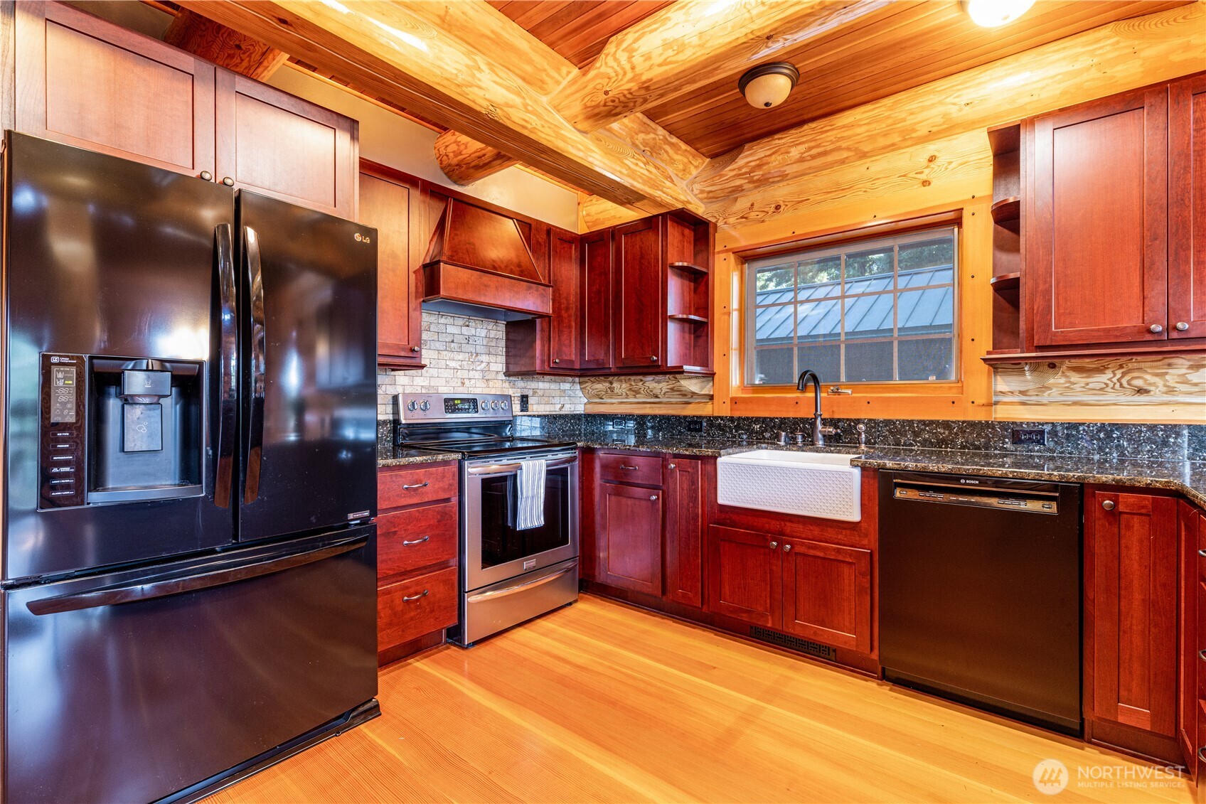 1901 E Trail Belfair, WA 98528 - Photo 5 of 40 a kitchen with stainless steel appliances granite countertop a stove a sink and a refrigerator