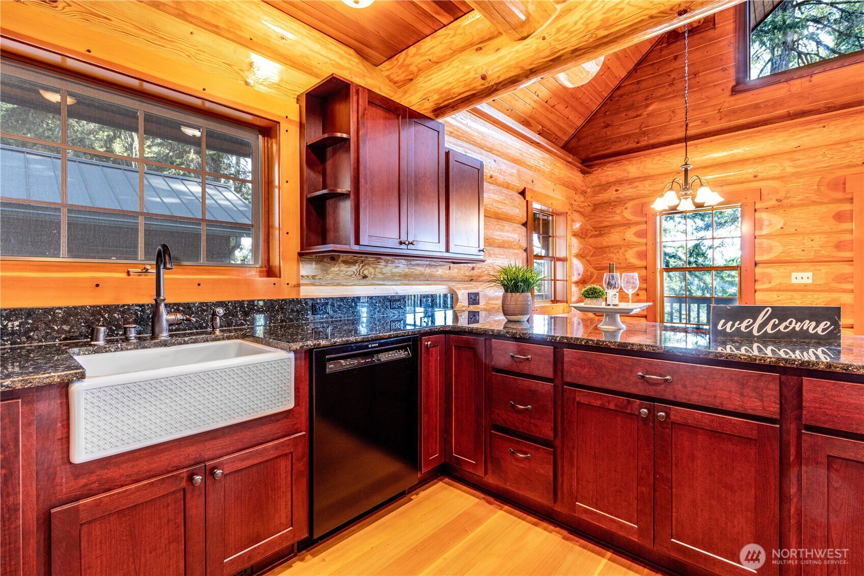 1901 E Trail Belfair, WA 98528 - Photo 6 of 40 a kitchen with stainless steel appliances granite countertop a sink and wooden cabinets