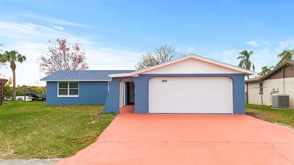 a view of a house with a yard and garage