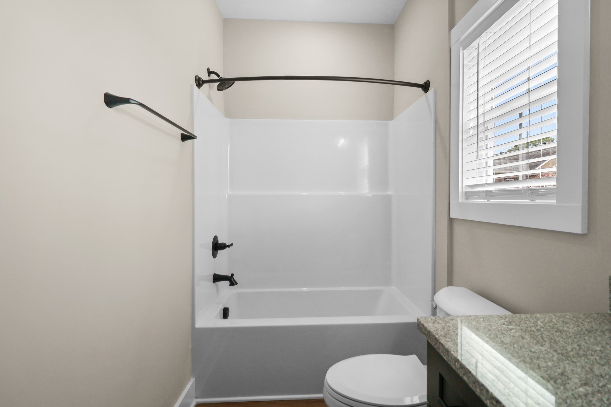1007 Oak Street, Unit A Portland, TN 37148 - Photo 19 of 29 a bathroom with a granite countertop toilet sink and bathtub