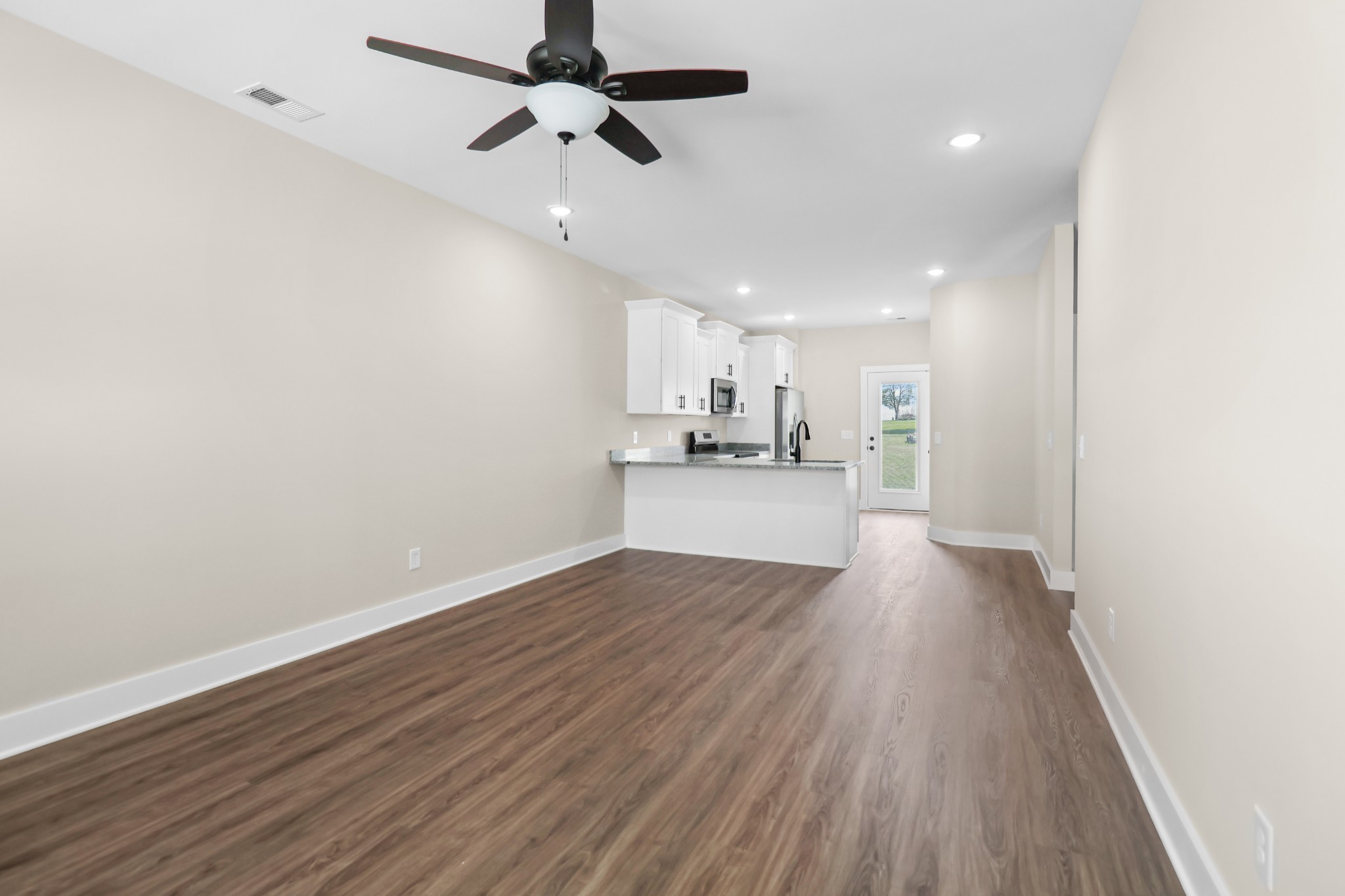 1007 Oak Street, Unit A Portland, TN 37148 - Photo 4 of 29 a view of a kitchen with stove and wooden floor