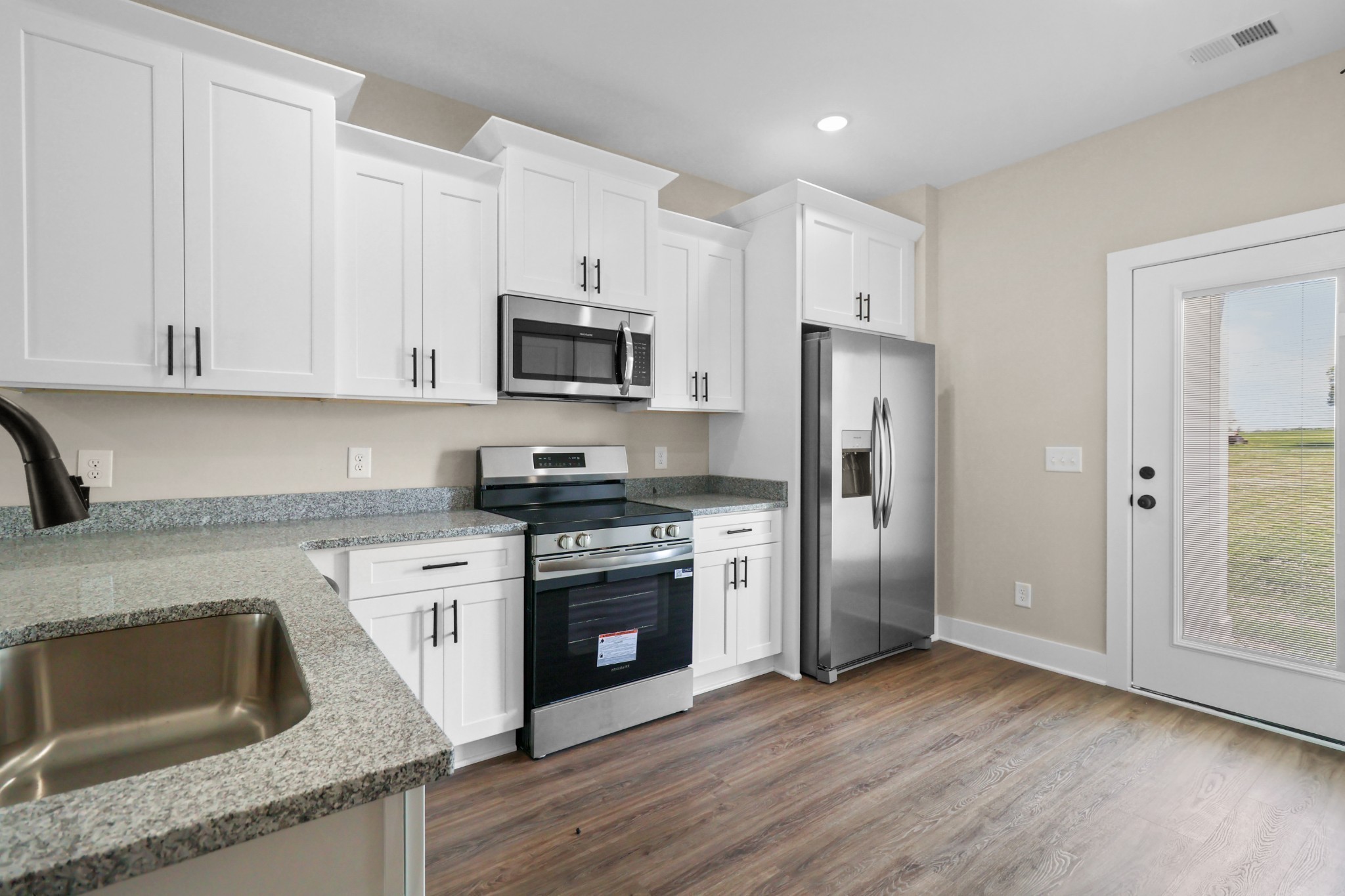 1007 Oak Street, Unit A Portland, TN 37148 - Photo 8 of 29 a kitchen with granite countertop a refrigerator stove and sink