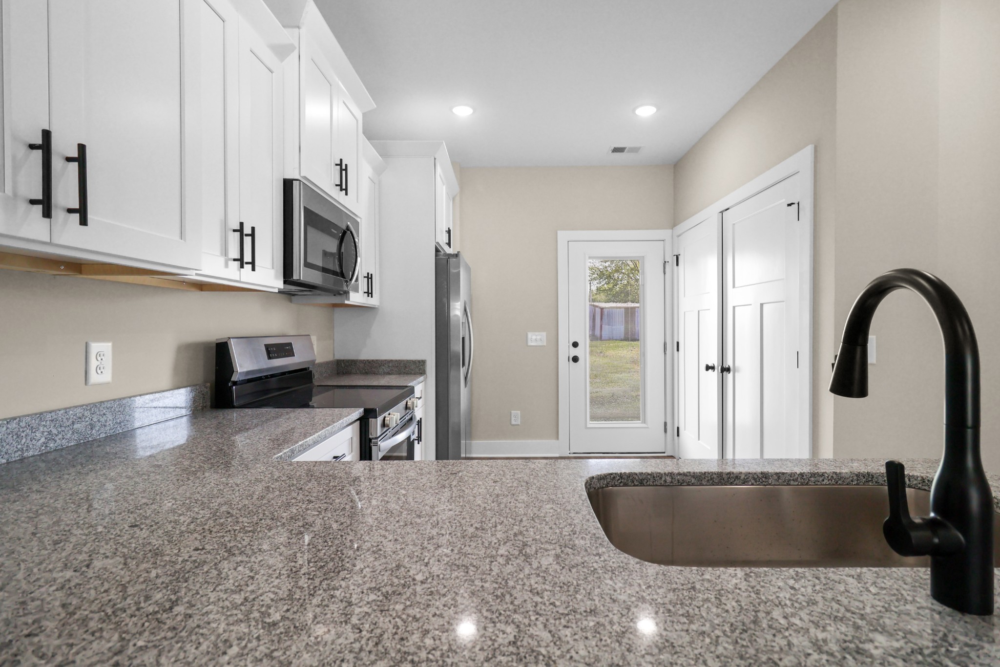 1007 Oak Street, Unit A Portland, TN 37148 - Photo 9 of 29 a kitchen with stainless steel appliances granite countertop a sink a stove and a granite counter tops