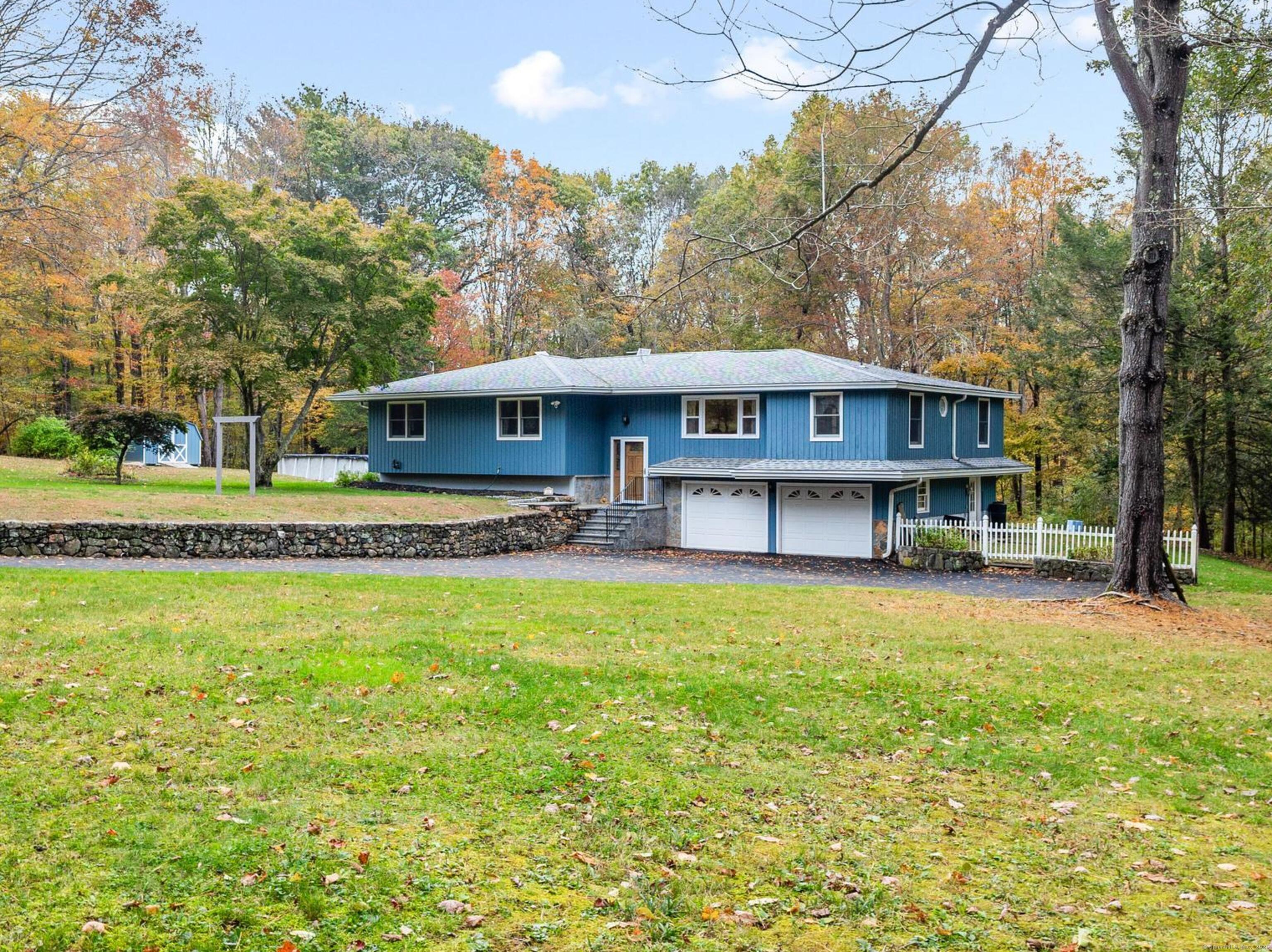 a front view of a house with a garden and swimming pool