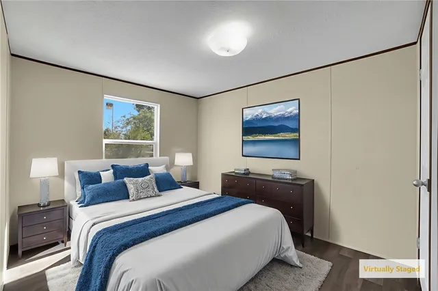 a bedroom with a bed and a painting on the wall