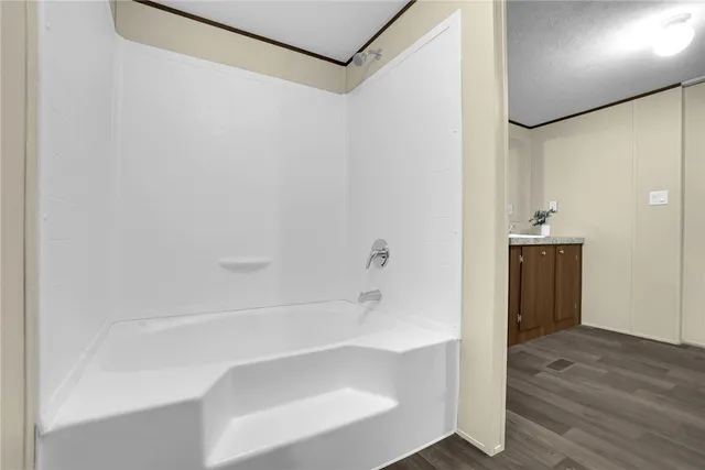 a bathroom with a tub and shower